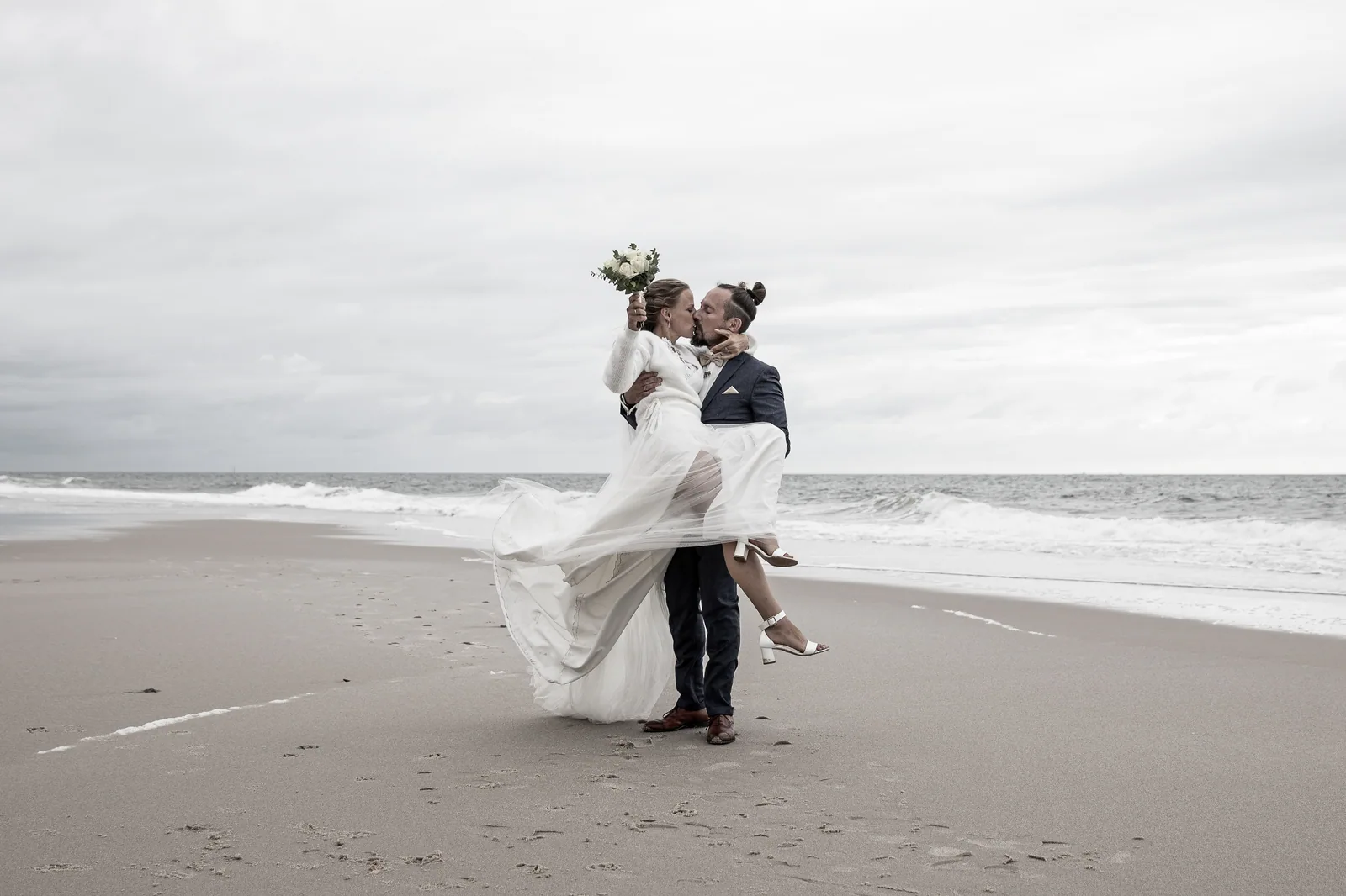 Hochzeitsfotografie — Brautpaar spaziert am Strand entlang